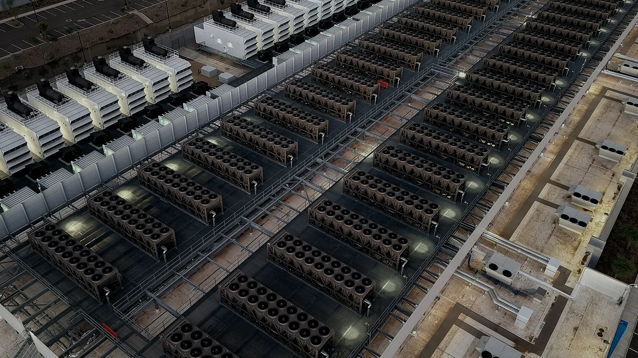 Aerial view of cooling units covering the roof of a large data centre at dusk